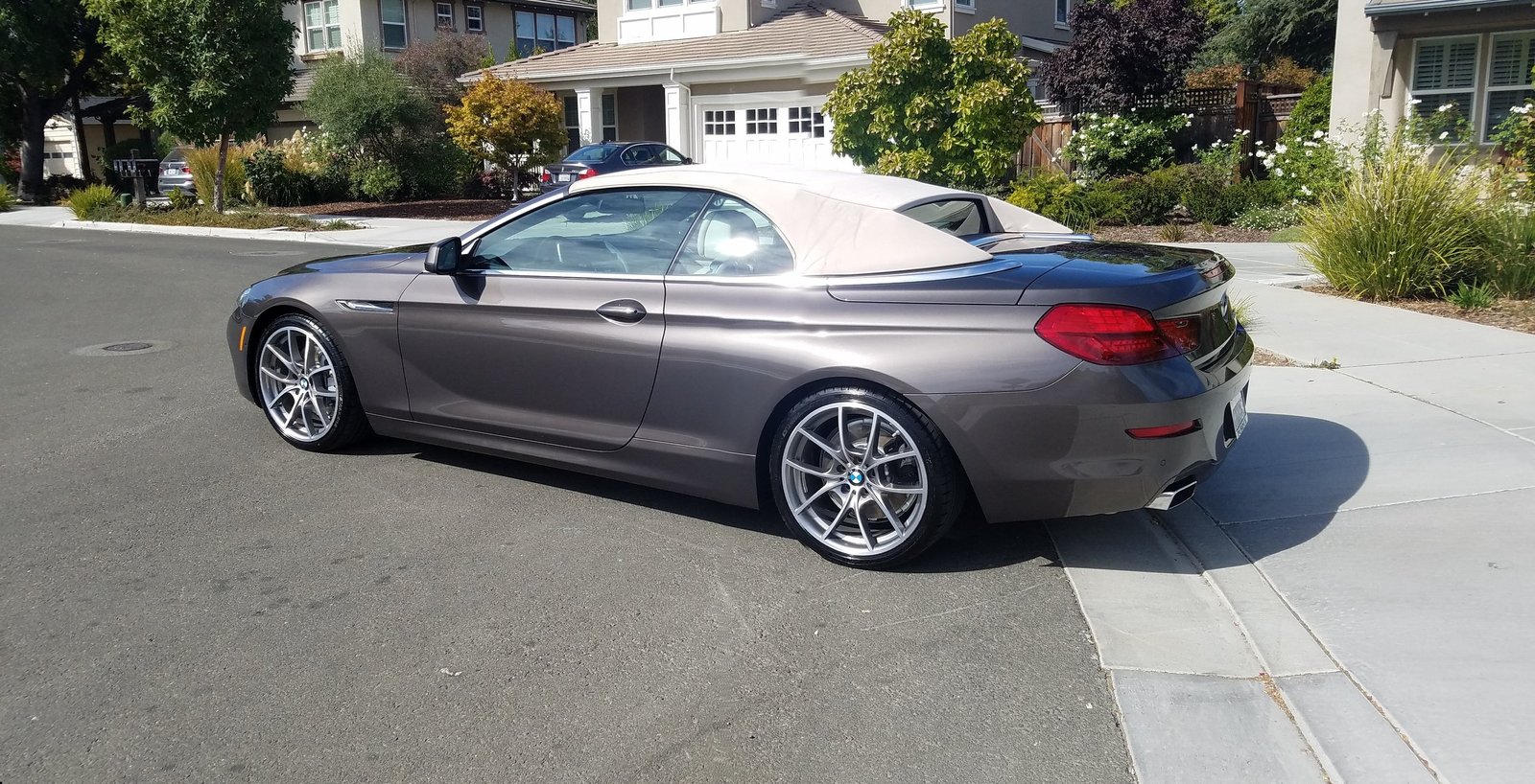 BMW convertible parked on the street after a professional detailing service.