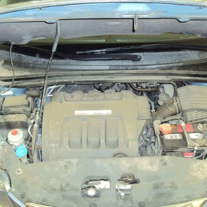 Dusty and dirty engine bay before detailing service.