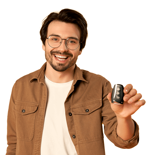 Smiling man holding a car key, wearing glasses and a brown jacket.