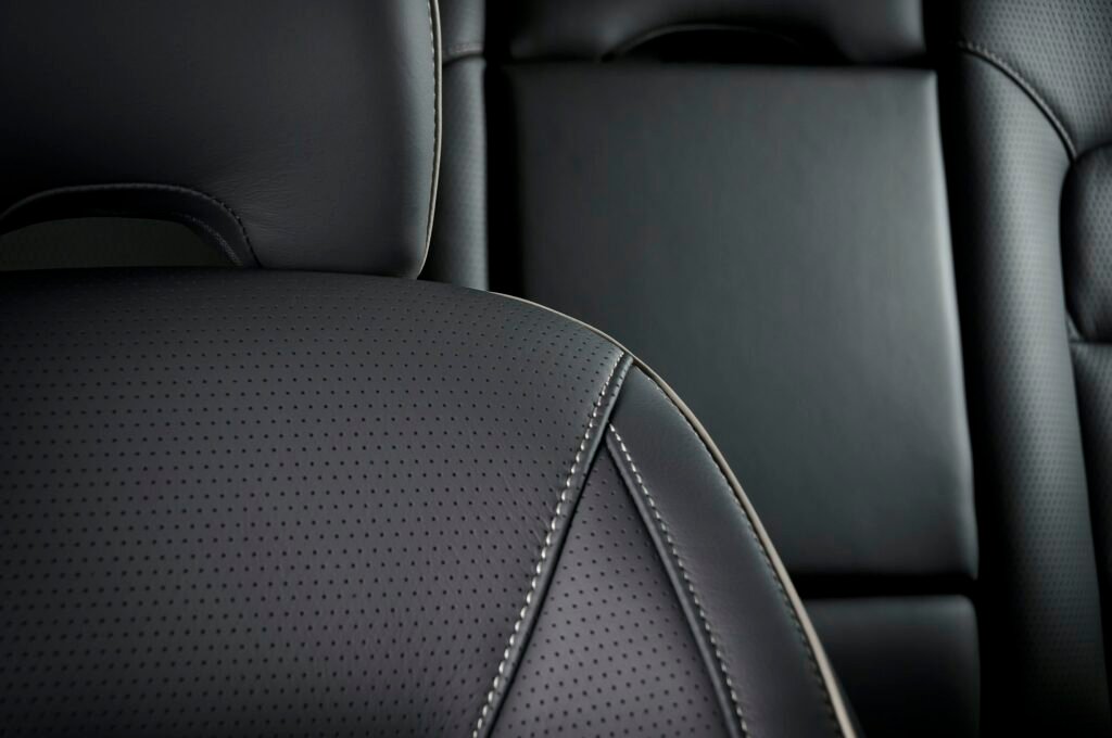 Close-up of modern black leather car seat in a sports car.