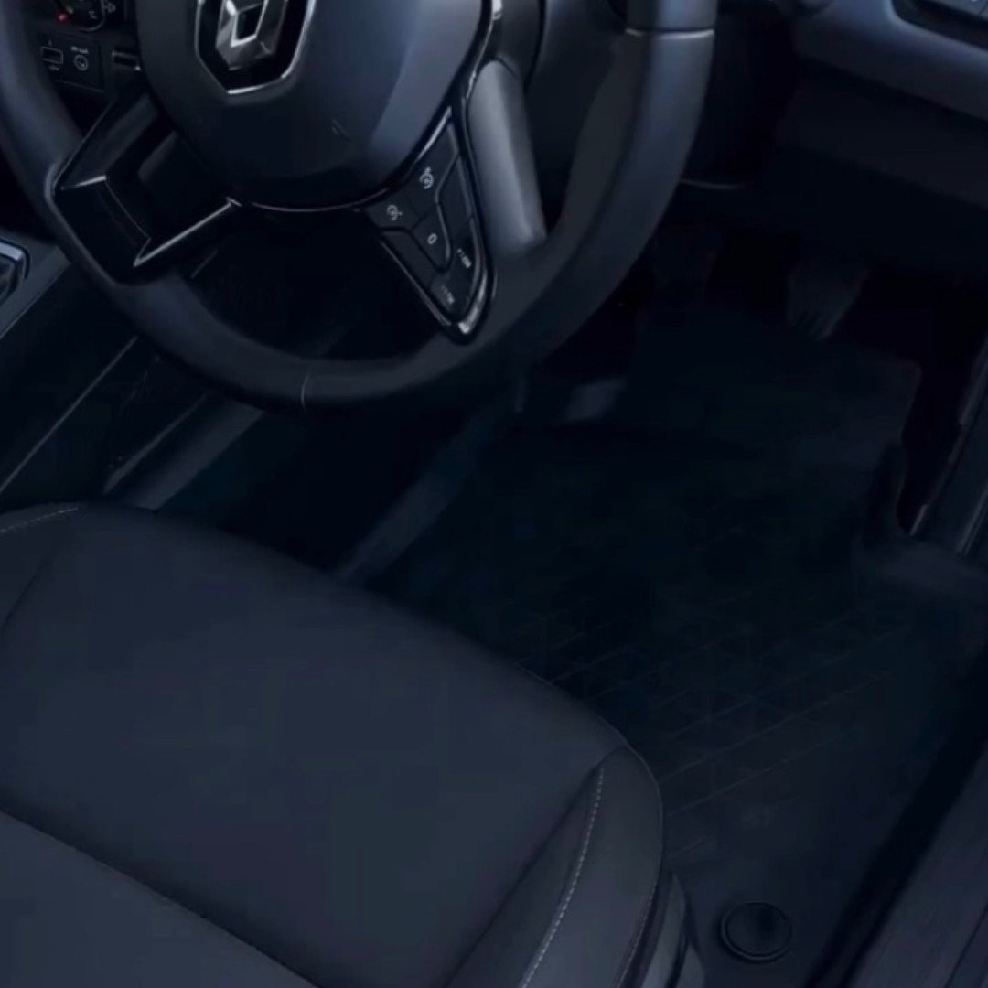 Clean and detailed interior of a car, focusing on the driver's seat and floor mat.